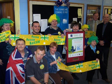 Moonya clients hold up their Best Dressed Business Award with Cr Neville Goodwin and Cr John Duscher (right)