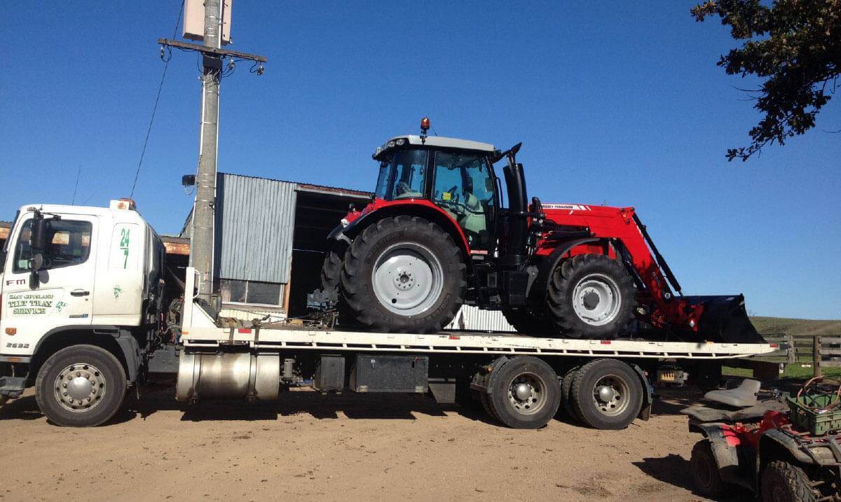 Hire a tilt tray truck to transport a tractor with East Gippsland Tilt Tray Service from Lakes Entrance