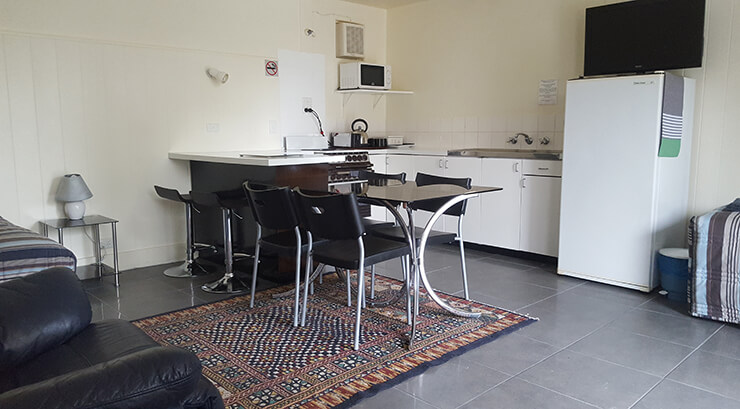 View of room 16 of the Meeniyan Motel showing dining table and kitchen - accommodation near Wilsons Promontory and the Great Southern Rail Trail with bike hire